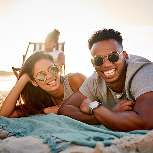 Woman and man smiling to the camera and being outdoors