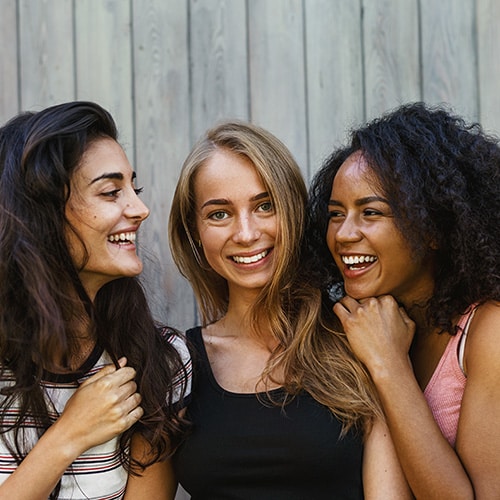 A group of teenagers laughing and smiling