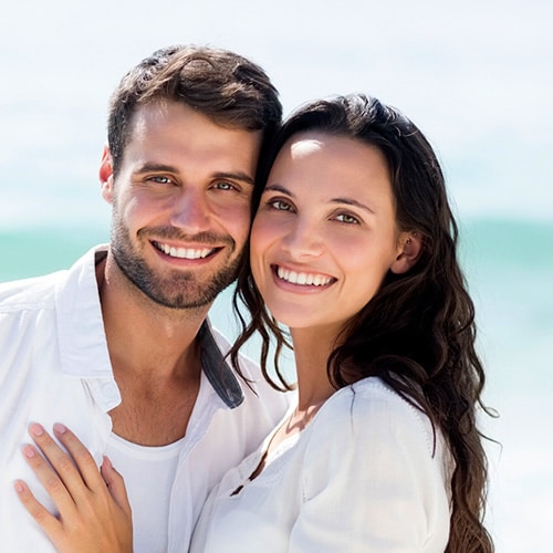 A man and a woman smiling into the camera